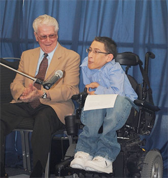 Nugent with a student speaking into microphone